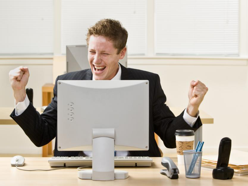 Hands celebrating at computer